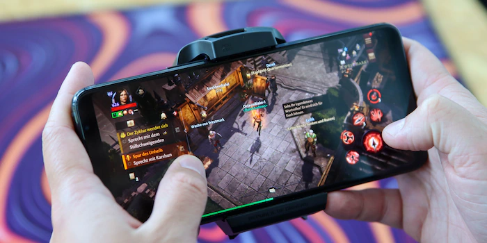 Smartphone displaying a fictional mobile game at an Australian gaming technology exhibition
